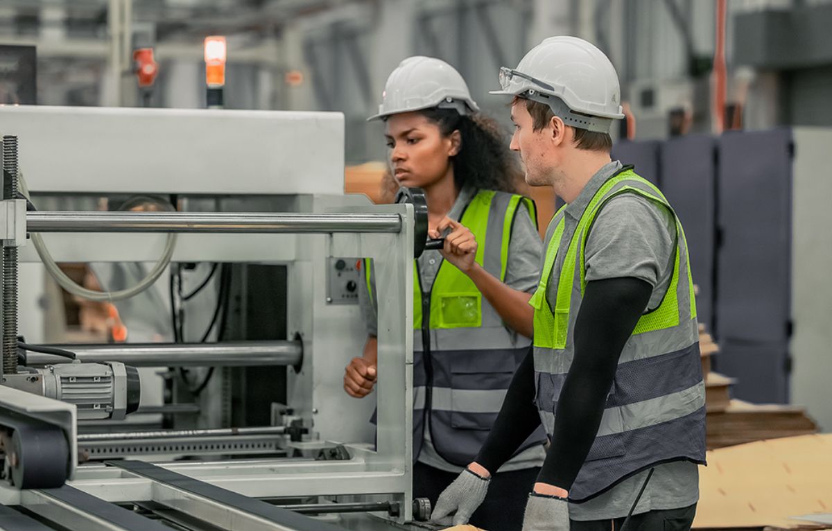 Two workers inspecting industrial equipment for anomalies