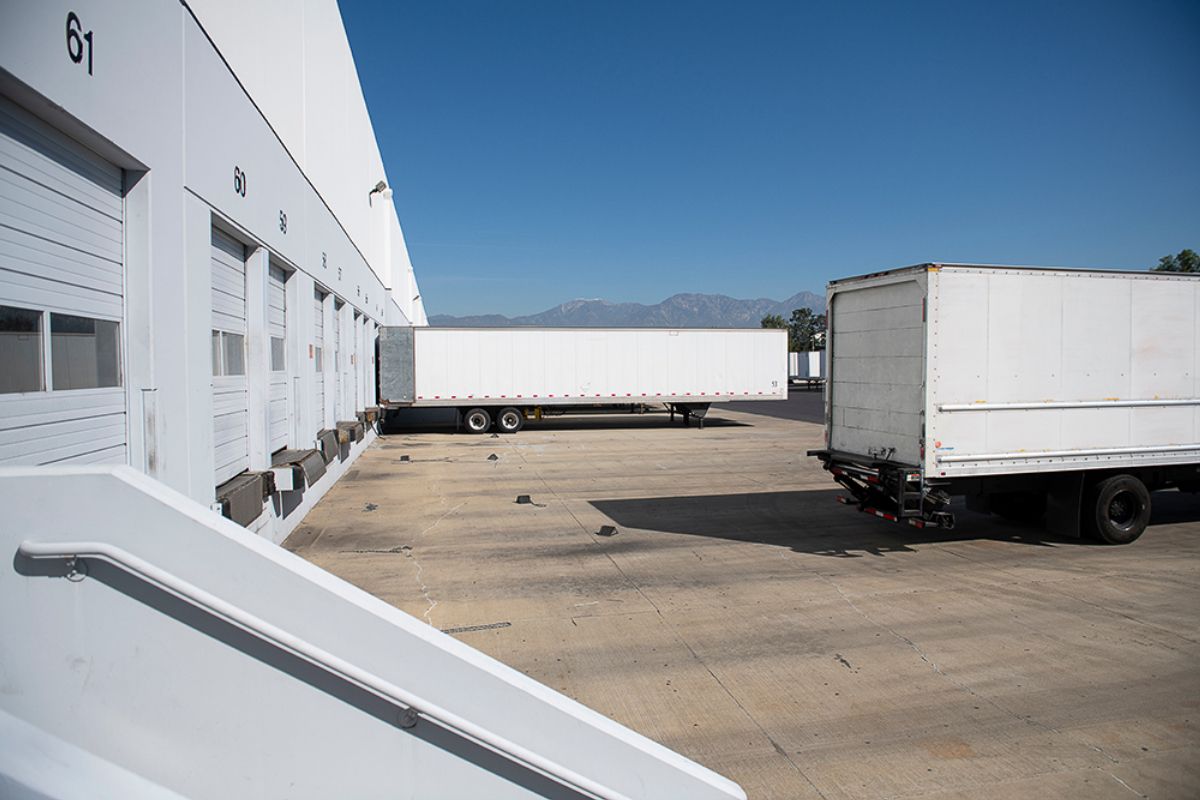 Loading dock with trucks at warehouse bay doors